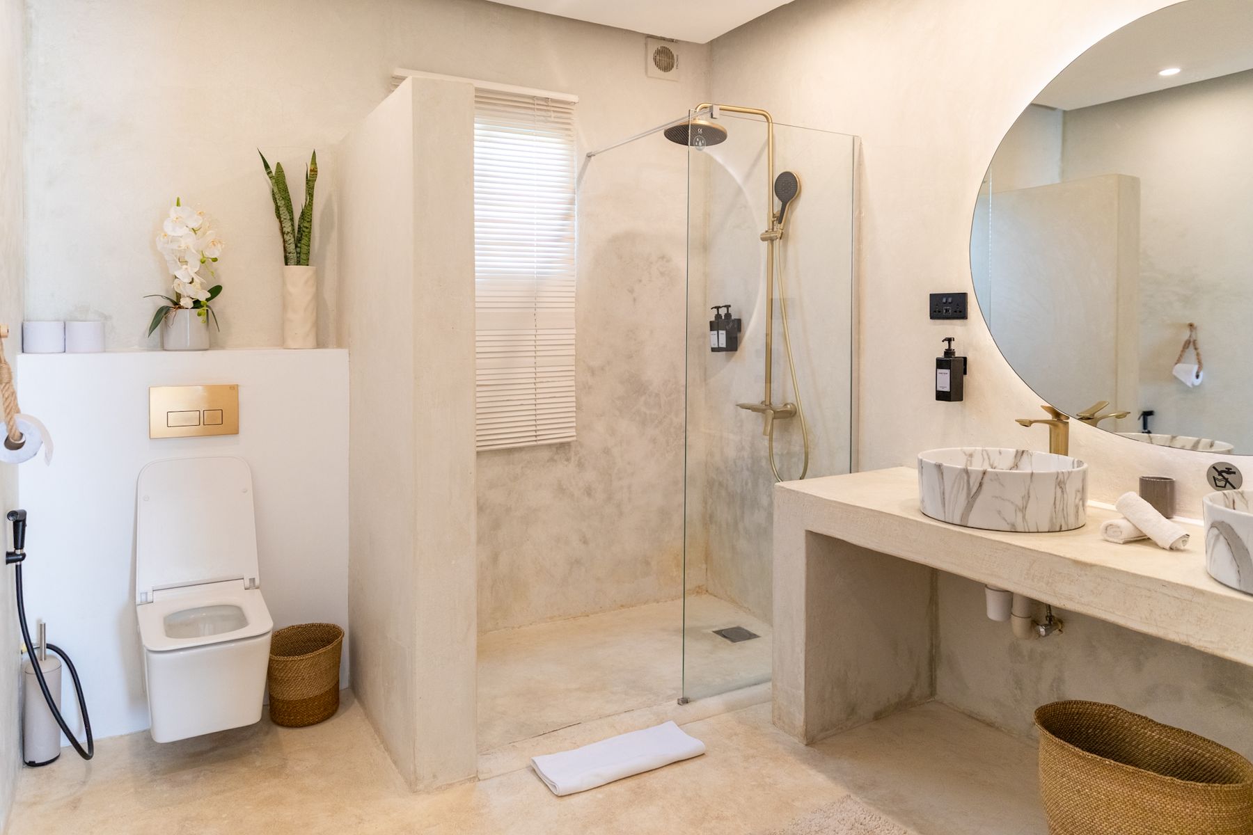 Suite bathroom with walk-in rain shower and stone vanity
